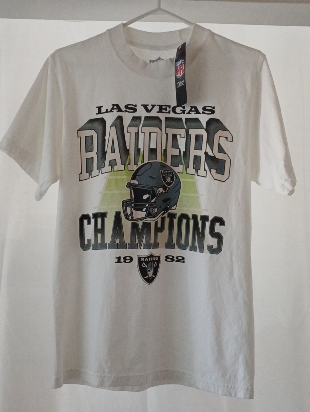 NFL Las Vegas Raiders White Graphic Tee with Helmet and Champions Print